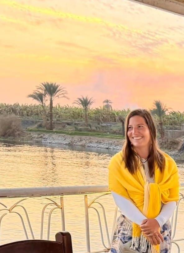 Sarah Meldrum, founder of The Luxorium, beside the Nile in Luxor at sunset.