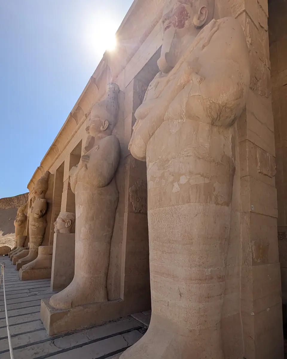 Sunlight falls across the statues at Hatshepsut’s temple at Deir el-Bahari in Luxor.